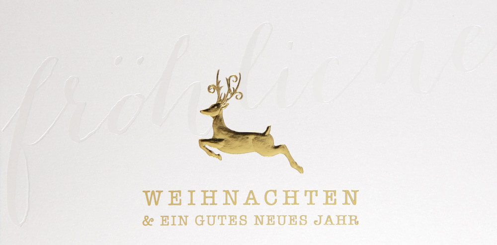 Perlmuttfarbene Weihnachtskarte mit springendem Hirsch und Weihnachtsgruß in gold