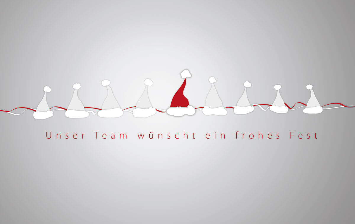 Fröhliche Team-Weihnachtskarte mit Bommelmützen auf der Leine