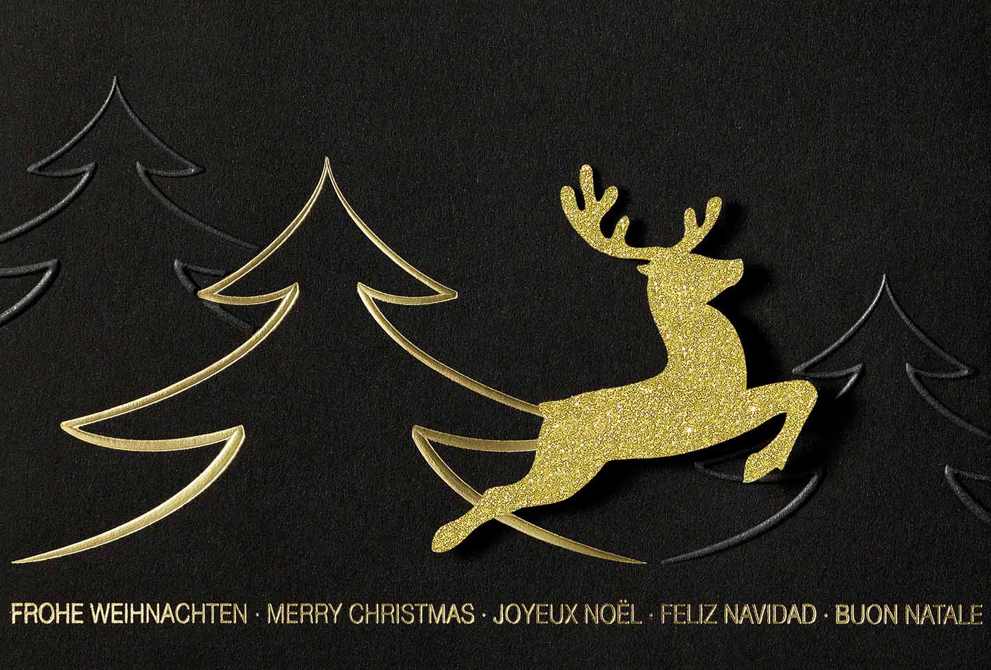 Moderne Weihnachtskarte mit internationalen Grüßen und glitzernder Hirsch-Applikation