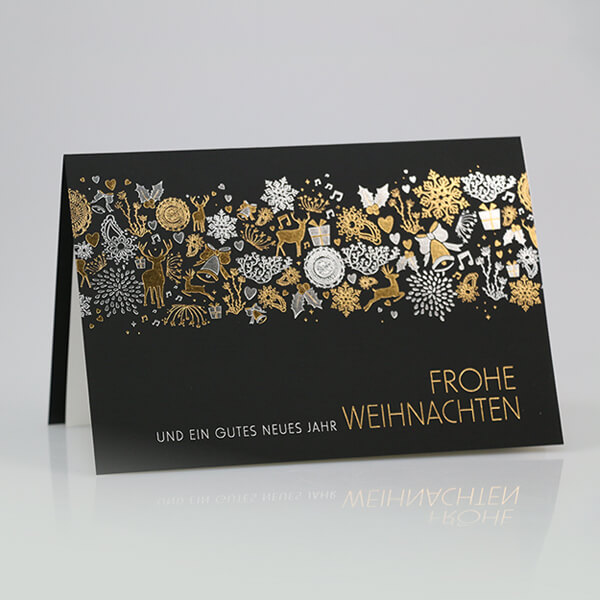 Schwarze Weihnachtskarte mit weihnachtlichen Motiven und goldenem Briefkuvert