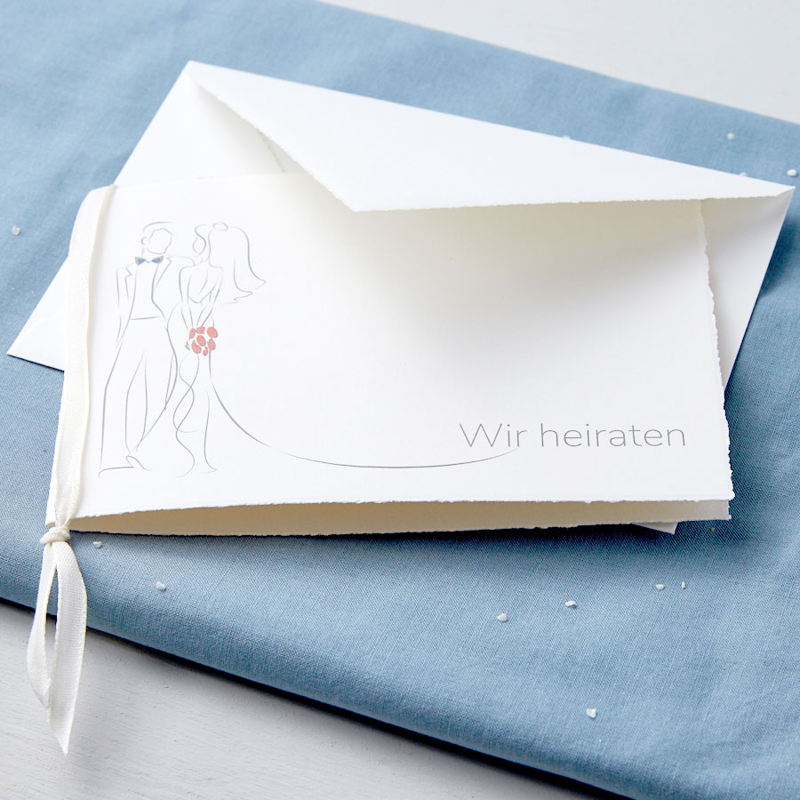 Cremeweiße Hochzeitskarte mit Braut und Bräutigam sowie Beispiel Schriftzug "Wir heiraten"