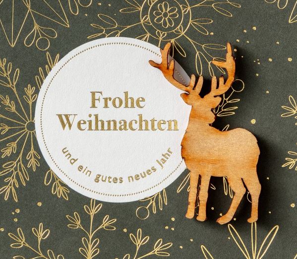 Detailansicht von goldenem Weihnachtsgruß und Hirsch aus Echtholz