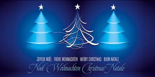 Blaue Weihnachtskarte mit internationalen Weihnachtsgrüßen und leuchtenden Bäumen, DIN lang